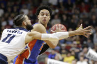 Florida's Andrew Nembhard, right, is defended by Nevada's Cody Martin (11) during the second half of a first round men's college basketball game in the NCAA Tournament in Des Moines, Iowa, Thursday, March 21, 2019. (AP Photo/Nati Harnik)