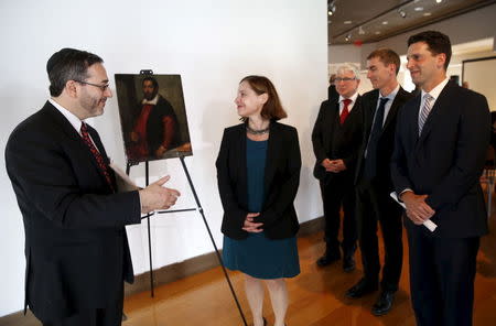 Mel Urbach, (L) an attorney representing the heir of holocaust victim Dr. August Liebmann Mayer, and Muriel de Bastier of France's Commission for the Compensation of Victims of Spoliation stand in front of the 17th century painting "Portrait of a Man" which belonged to Dr. Mayer, at a ceremony at the Jewish Heritage Museum in New York officially returning the painting to the Mayer family, May 5, 2015. The 17th century painting taken by Nazis from a prominent German Jewish art historian has been returned to the owner's daughter, New York state officials said on Tuesday. REUTERS/Mike Segar