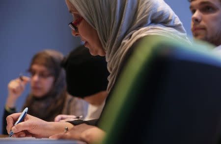 Students pursuing a diploma in "Multiculturalism, Secularism and Religion" listen to Professor Philippe Gaudin in a classroom at the Catholic University of Paris (ICP) March 13, 2015. REUTERS/Christian Hartmann