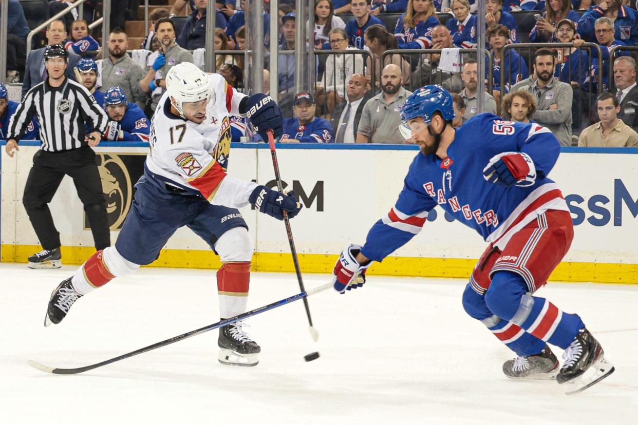 May 24, 2024; New York, New York, USA; Florida Panthers center Evan Rodrigues (17) shoots the puck asNew York Rangers defenseman Erik Gustafsson (56) defends during the first period in game two of the Eastern Conference Final of the 2024 Stanley Cup Playoffs at Madison Square Garden. Mandatory Credit: Vincent Carchietta-USA TODAY Sports