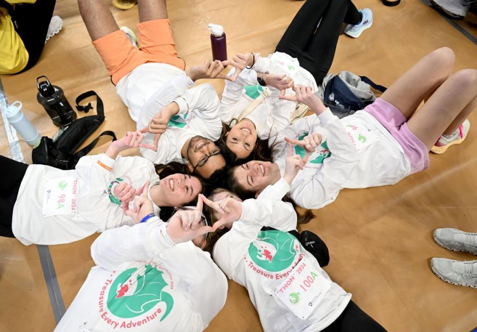 The dancers for Phi Beta Lambda lay together on the floor holding up diamonds before standing for the 46 hour Penn State IFC/Panhellenic Dance Marathon on Friday, Feb. 16, 2024 at the Bryce Jordan Center.