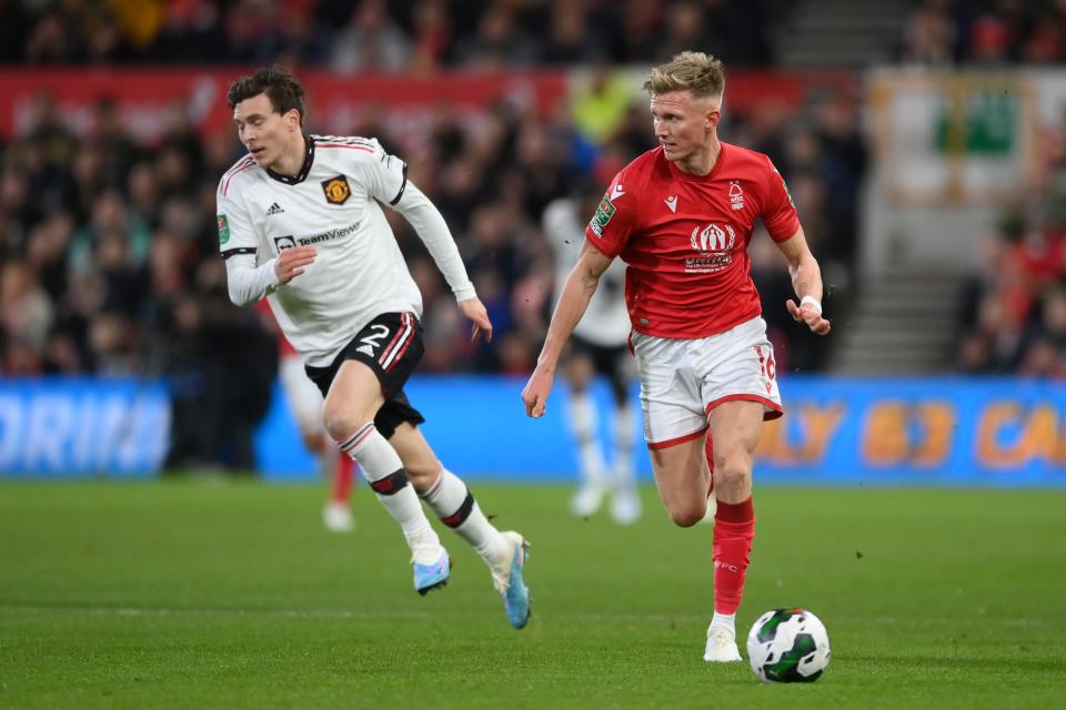 NOTTINGHAM, ENGLAND - JANUARY 25: Sam Surridge of Nottingham Forest runs with the ball from Victor Lindelof of Manchester United during the Carabao Cup Semi Final 1st Leg match between Nottingham Forest and Manchester United at City Ground on January 25, 2023 in Nottingham, England.