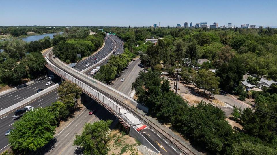 A bridge carries the Del Rio Trail, shown in a drone photo on Thursday, over Riverside Boulevard and Interstate 5 at the north end of its nearly five-mile route through Sacramento. While the rest of the trail is officially open, the bridge won’t be ready until summer.