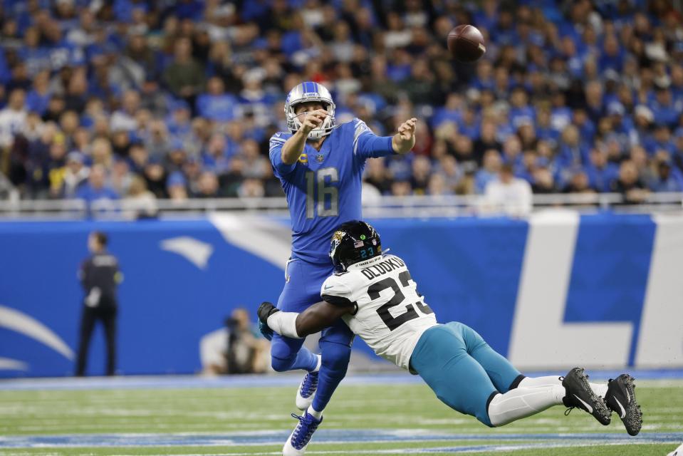 Detroit Lions quarterback Jared Goff (16) Jacksonville Jaguars linebacker Foyesade Oluokun (23) as he passes in the first half during an NFL football game, Sunday, Dec. 4, 2022, in Detroit. (AP Photo/Rick Osentoski)