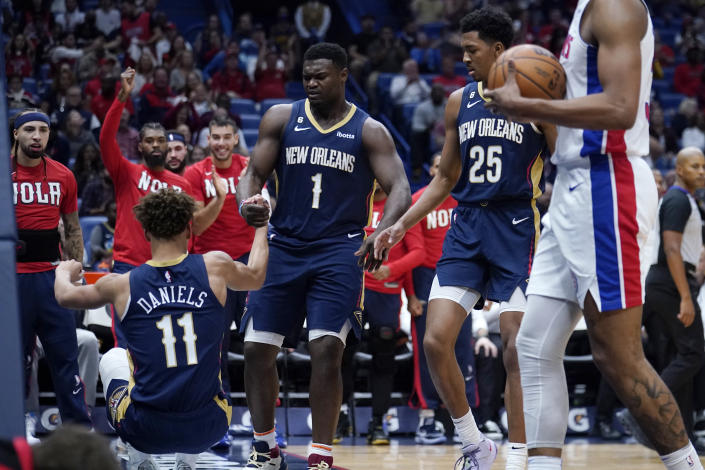 New Orleans Pelicans forward Zion Williamson (1) helps up guard Dyson Daniels (11) after Daniels was fouled as he scored a basket in the first half of an NBA basketball game against the Detroit Pistons in New Orleans, Wednesday, Dec. 7, 2022. (AP Photo/Gerald Herbert)