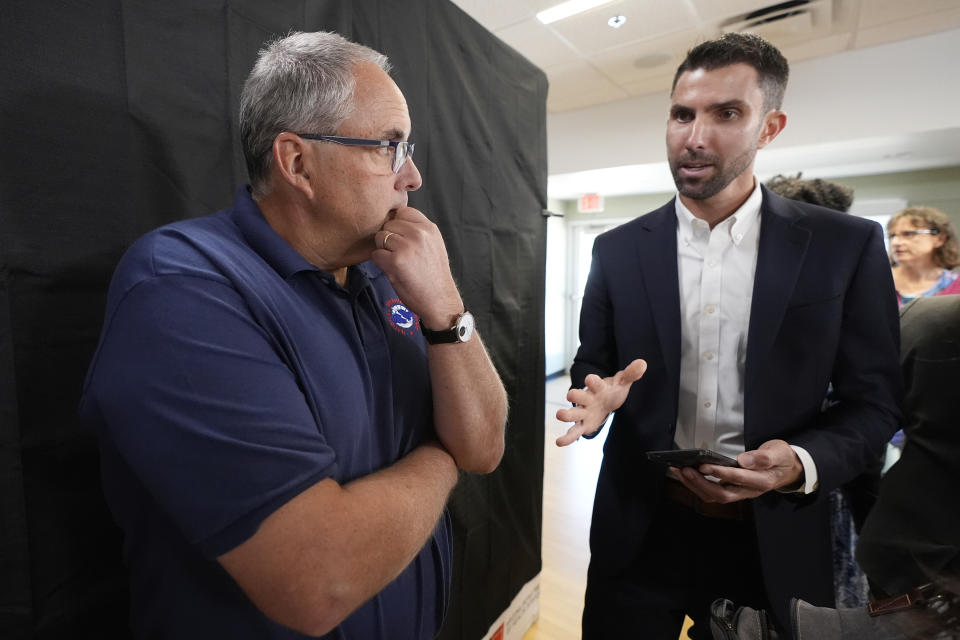 David Hondula, right, Ph.D., Director of Heat Response and Mitigation with the City of Phoenix, speaks with Tom Frieders, National Weather Service Warming Coordinator Meteorologist, after a news conference held by the Arizona Department of Health Services and Governor's Office of Resiliency ahead of Heat Awareness Week at the Escalante Multi-Generational Center Friday, May 3, 2024, in Tempe, Ariz. (AP Photo/Ross D. Franklin)