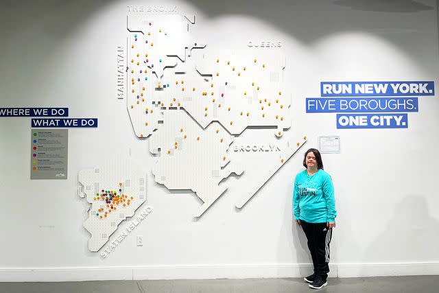 <p>Sandy Williamson</p> Kayleigh Williamson standing in front of the map of the New York City before race day.