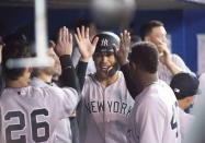 Mar 29, 2018; Toronto, Ontario, CAN; New York Yankees right fielder Giancarlo Stanton (27) celebrates scoring a run in the fifth inning during the Toronto Blue Jays home opener at Rogers Centre. Mandatory Credit: Nick Turchiaro-USA TODAY Sports