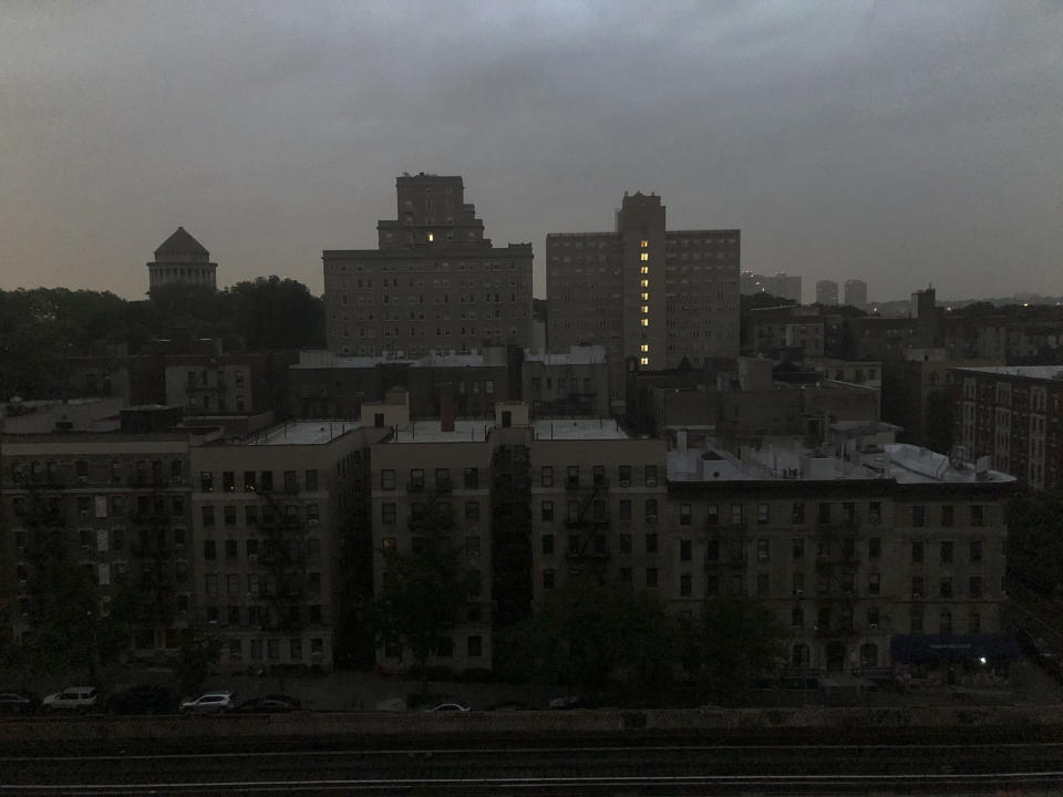 Buildings in Harlem sit dark during a power outage early, Friday, Aug. 7, 2020, in New York. A power outage cast darkness across dozens of blocks in New York City as many people in the city were still without electricity in the aftermath of Tropical Storm Isaias. Con Edison said that a problem with its transmission system "caused three networks in Manhattan to lose their electric supply," just after 5 a.m. (AP Photo/Candice Choi)