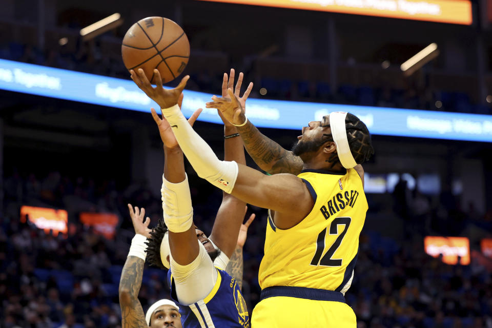 Indiana Pacers forward Oshae Brissett (12) shoots against Golden State Warriors center Kevon Looney (5) during the first half of an NBA basketball game in San Francisco, Thursday, Jan. 20, 2022. (AP Photo/Jed Jacobsohn)