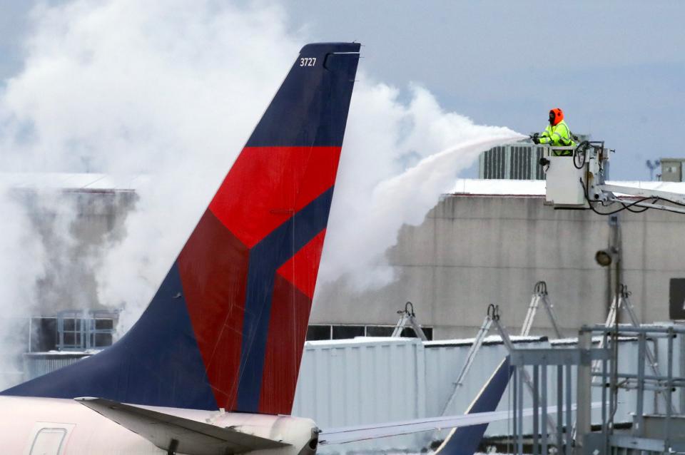 De-icing solution is sprayed over a Delta flight at Louisville Muhammad Ali International Airport on Monday, January 15, 2024