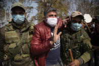 Indian police detain an activist of Peoples Democratic party (PDP) protesting against India's new land laws that allows any Indian citizen to buy land in the disputed region in Srinagar, Indian controlled Kashmir, Thursday, Oct. 29, 2020. Until last year, Indians were not allowed to buy property in the region. But in August 2019, Prime Minister Narendra Modi’s government scrapped the disputed region’s special status, annulled its separate constitution, split the region into two federal territories. (AP Photo/Mukhtar Khan)