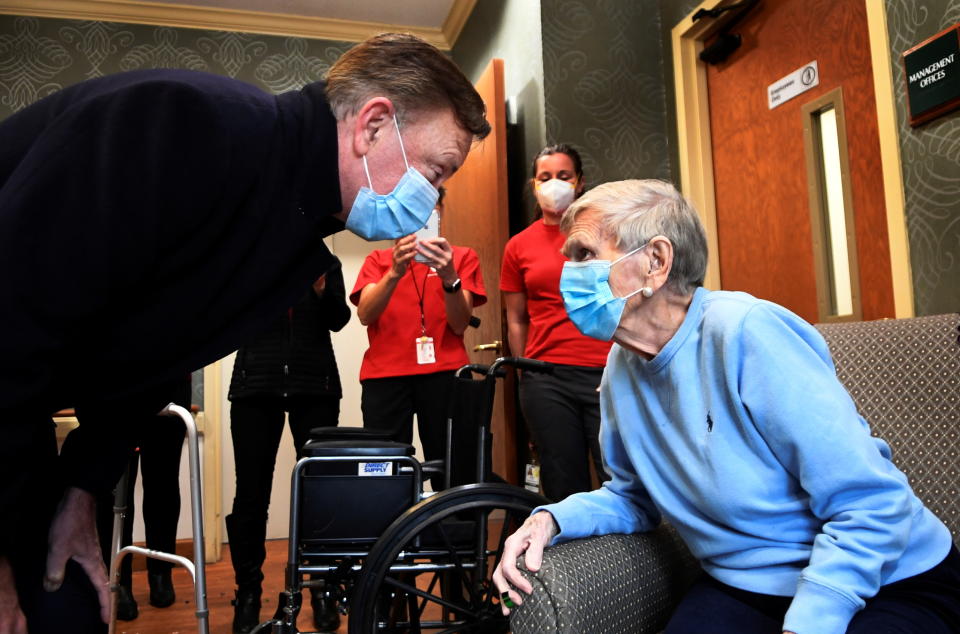 Governor Ned Lamont greets Jeanne Peters, 95, a rehab patient at The Reservoir, a nursing facility, after she was given the first coronavirus disease (COVID-19) vaccination at the nursing home, in West Hartford, Connecticut, U.S., December 18, 2020. Stephen Dunn/Pool via REUTERS