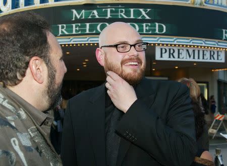 Andy Wachowski (R), the co-director of the new film "The Matrix Reloaded" talks with the film's producer Joel Silver (L) at the film's premiere in Los Angeles, California in this May 7, 2003 file photo. "The Matrix" filmmaker Lilly Wachowski, formerly known as Andy, came out as a transgender woman on March 8, 2016 in a candid post entitled "Sex change shocker - Wachowski brothers now sisters!!!," four years after her sister Lana Wachowski revealed she was a transgender woman. REUTERS/Fred Prouser/Files