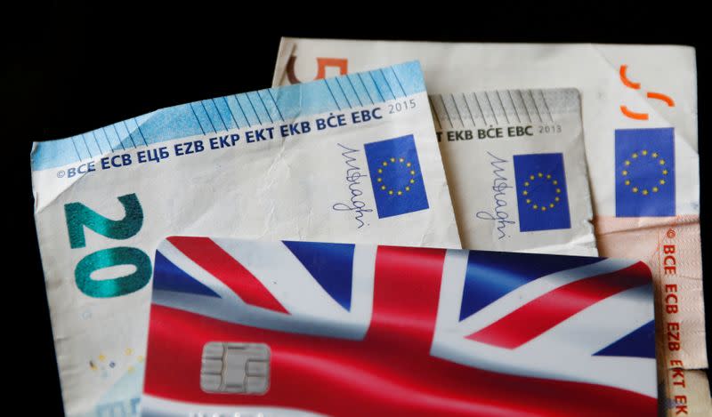 A Union Jack themed Visa credit card is seen amongst Euro bank notes in this photo illustration taken in Manchester, Britain