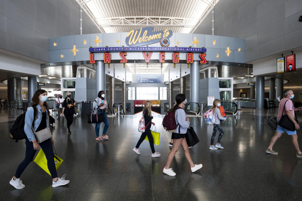 Airline passengers wearing face masks arrive and depart the D Concourse at McCarran International Airport in Las Vegas on Tuesday, June 30, 2020. (Photo By Bill Clark/CQ-Roll Call, Inc via Getty Images)