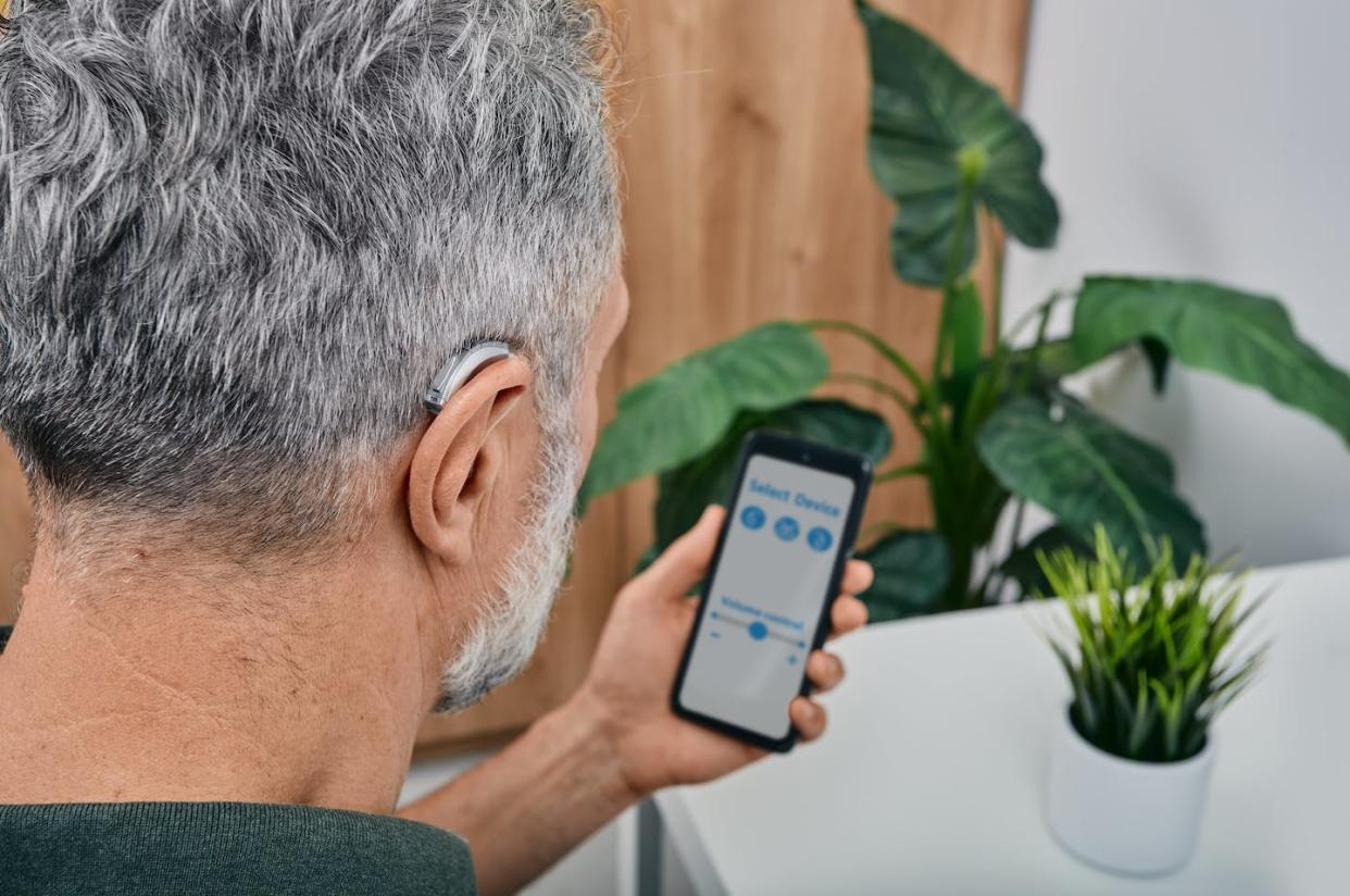 Now that over-the-counter hearing aids are available, it's important to know what questions to ask. <a href="https://www.gettyimages.com/detail/photo/hearing-impaired-mature-man-adjusts-settings-for-royalty-free-image/1364368694?phrase=hearing%2Baids" rel="nofollow noopener" target="_blank" data-ylk="slk:peakSTOCK/iStock via Getty Images Plus;elm:context_link;itc:0;sec:content-canvas" class="link ">peakSTOCK/iStock via Getty Images Plus</a>