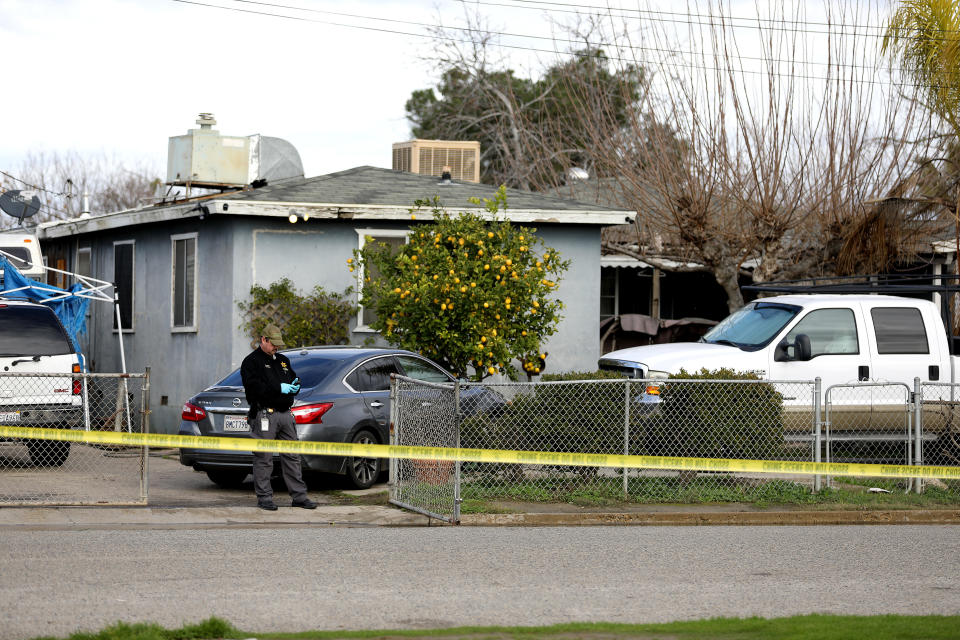 Tulare County Sheriff's Office investigators at the scene of where six people were killed in a Central Valley farming community on Jan. 16, 2023, in Goshen, CA. / Credit: Gary Coronado / Los Angeles Times via Getty Images