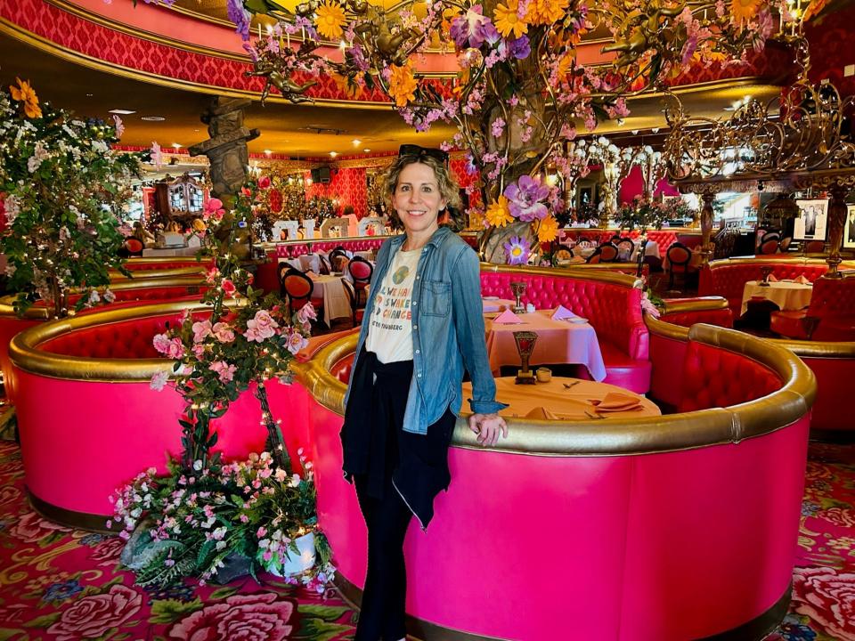 Woman stood is lavishly decorated room in the Madonna Inn in San Luis Obispo, CA.