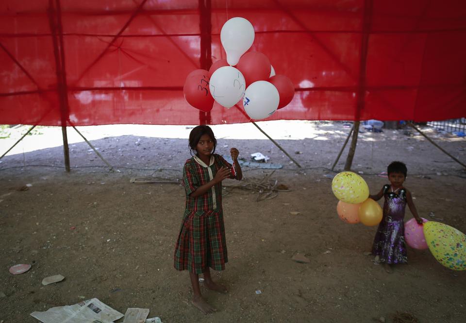 A girl holds balloons with 377 written on them collected from a protest organised by gay rights activists against the Supreme Court's order on gay sex in Mumbai December 11, 2013. India's Supreme Court on Wednesday threw out a 2009 ruling by a lower court that had decriminalised gay sex, in a major blow to gay rights in the world's largest democracy. Section 377 of India's penal code bans "sex against the order of nature", which is widely interpreted to mean homosexual sex, and can be punished with up to 10 years in jail. (REUTERS/Danish Siddiqui)