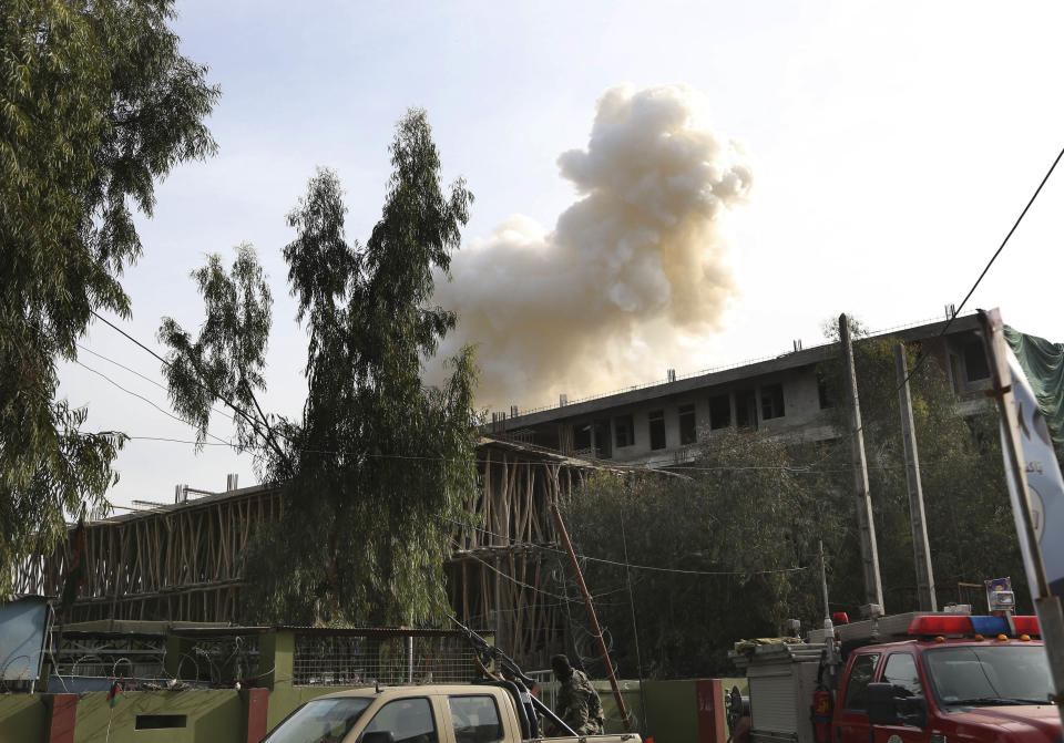 Smoke billows from a building after an attack on a police station in Jalalabad, the capital of eastern Nangarhar province, Afghanistan, Thursday, March 20, 2014. Taliban insurgents staged a multi-pronged attack on the police station, using a suicide bomber and gunmen to lay siege to the station, government officials said. Two remotely detonated bombs also exploded nearby. (AP Photo/Rahmat Gul)