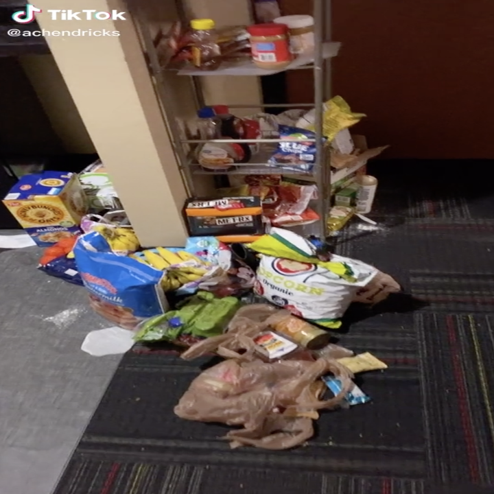 Messy hall area with food.