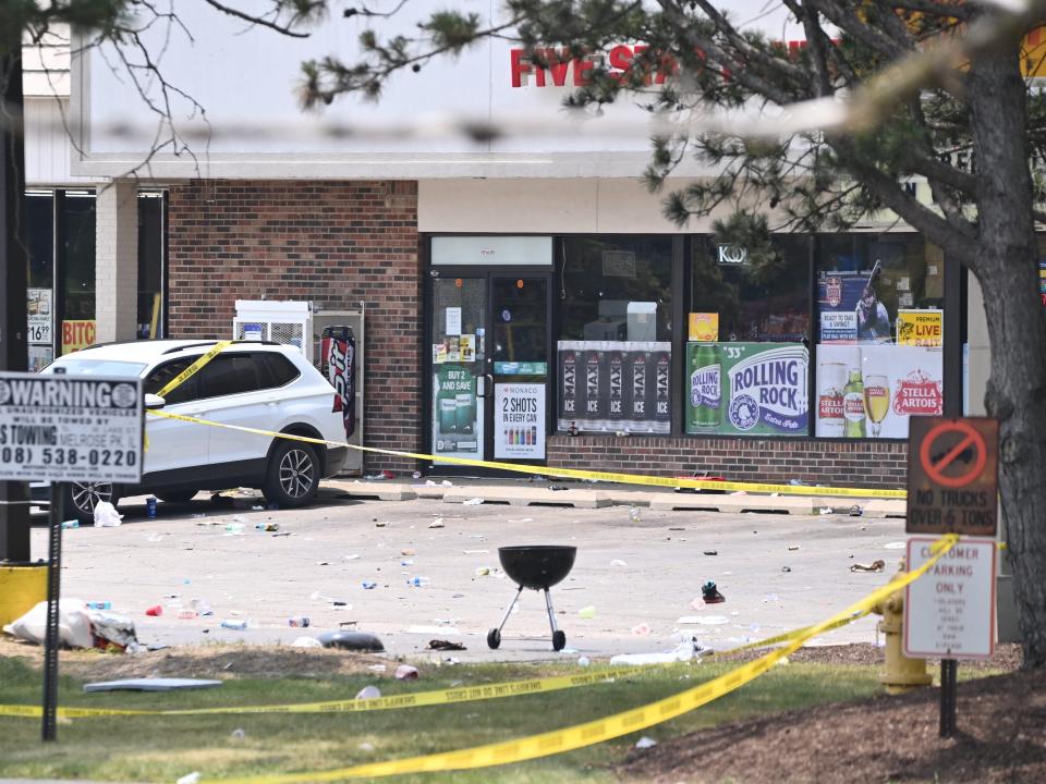 Police cordon off the area where at least one person was killed and 22 others wounded in a shooting just after midnight Sunday at a large Juneteenth celebration in a strip mall parking lot in Willowbrook, Illinois.