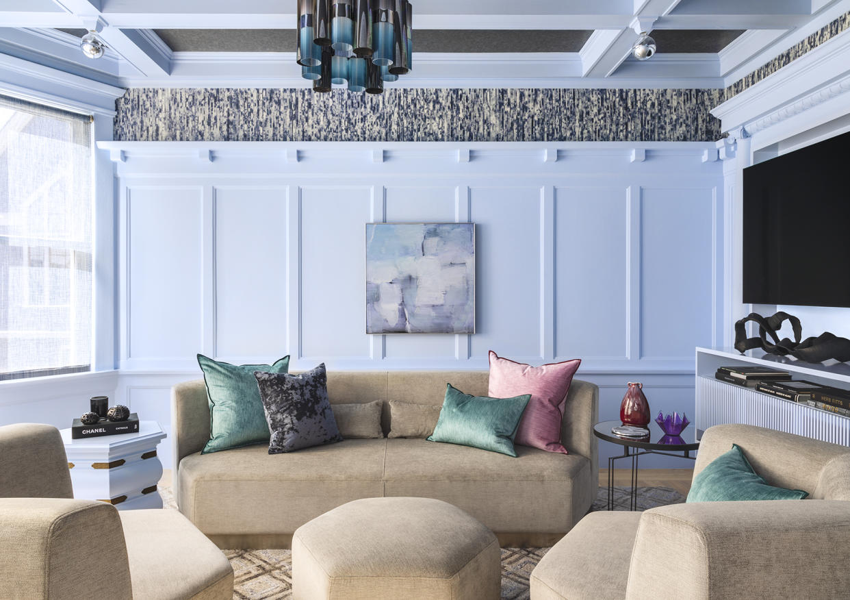  A living room with light blue walls and a brown sofa. 