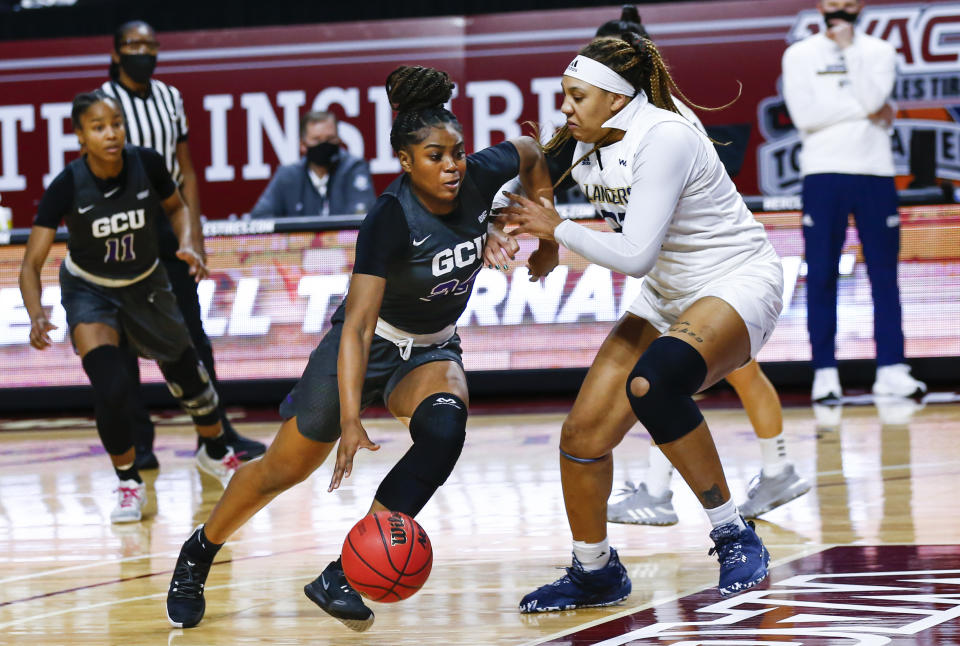 Grand Canyon's Tiarra Brown (24) drives to the basket against California Baptist's Britney Thomas (32) during the first half of an NCAA college basketball game for the championship of the Western Athletic Conference women's tournament Saturday, March 13, 2021, in Las Vegas. (AP Photo/Chase Stevens)