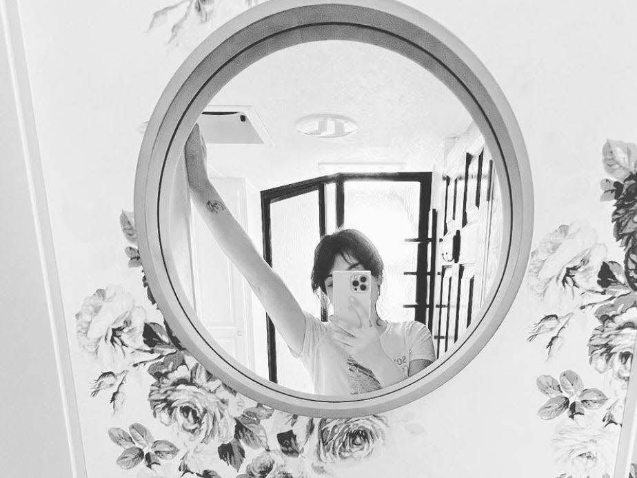 The renovator takes a mirror selfie in black and white