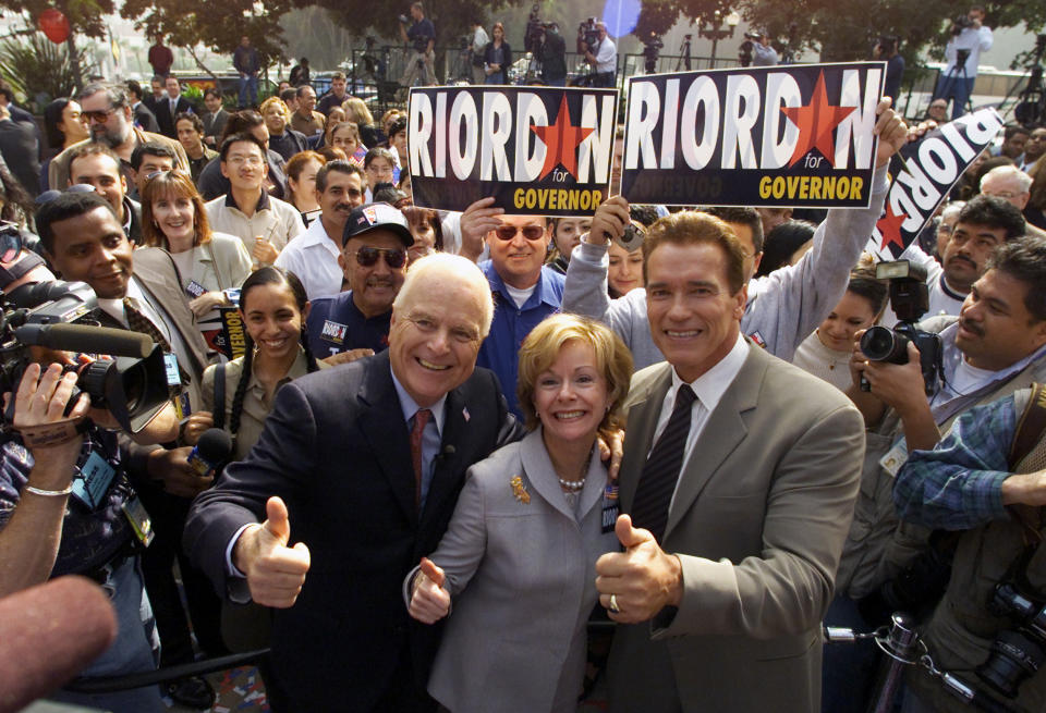 FILE - Former Los Angeles Mayor Richard Riordan, left, and his wife Nancy give thumbs up with actor Arnold Schwarzenegger, Tuesday Nov. 6, 2001, at a rally at Plaza Olvera in downtown Los Angeles. Riordan announced he is joining the field of Republicans seeking the nomination to unseat Democrat Gov. Gray Davis. Riordan, the moderate Republican multimillionaire who won two terms as mayor in Democrat-friendly Los Angeles and ran unsuccessfully for governor, died Wednesday, April 19, 2023. He was 92. (AP Photo/Damian Dovarganes, File)