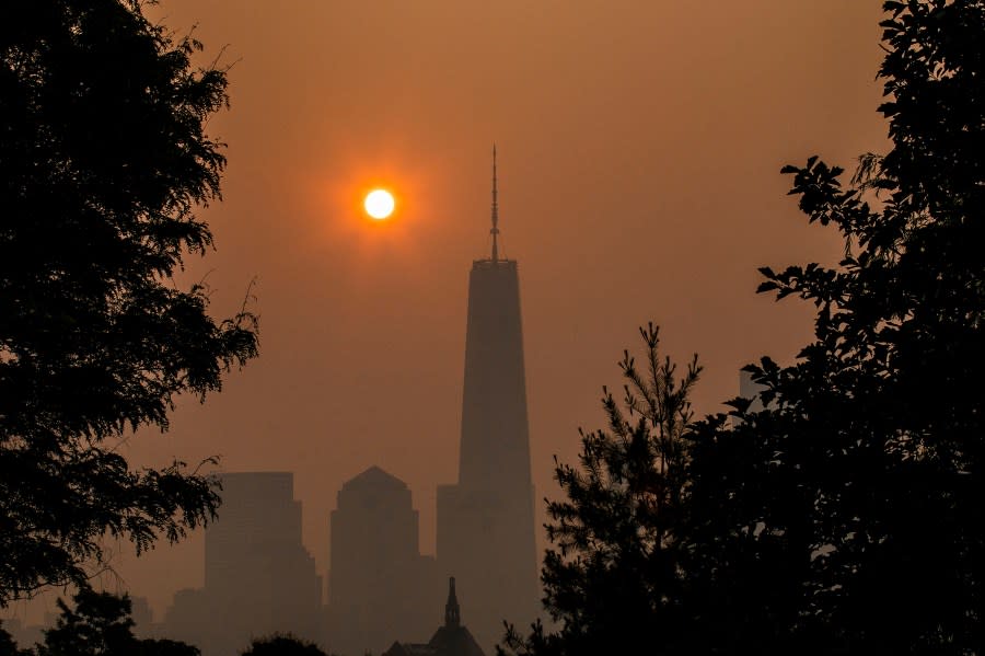 JERSEY CITY, NEW JERSEY – JUNE 8: The sun rises behind the One World Trade Center in New York, while the smoke from Canada wildfires covers the Manhattan borough as it is seen from Liberty State Park on June 8, 2023 in New Jersey. (Photo by Eduardo Munoz Alvarez/Getty Images)