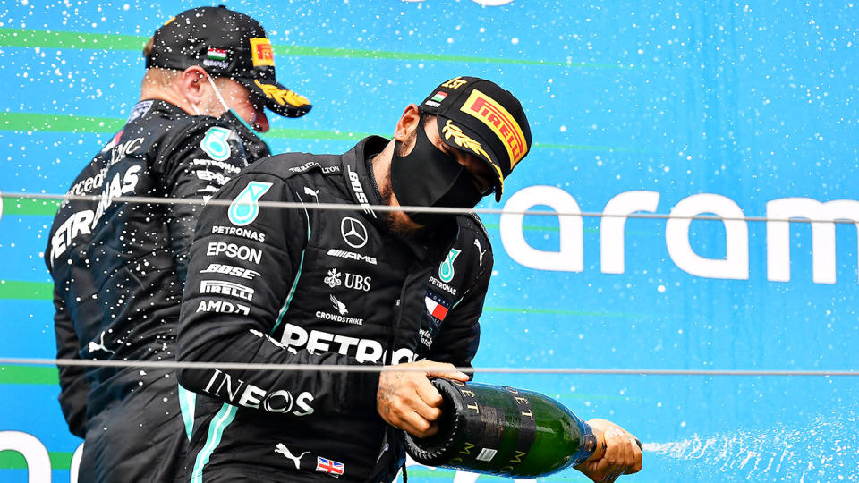 Pictured here, Lewis Hamilton pops the champagne after winning the Hungarian GP. 