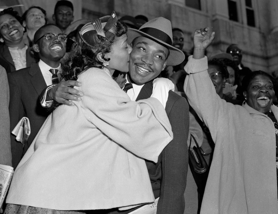 FILE - In this March 22, 1956, file photo, the Rev. Martin Luther King Jr. is welcomed with a kiss by his wife, Coretta, after leaving court in Montgomery, Ala. Gene Herrick, a retired Associated Press photographer who covered the Korean War and is known for his iconic images of Martin Luther King Jr., Rosa Parks and the trial of the killers of Emmett Till in the early years of the Civil Rights Movement, died Friday, April 12, 2024. He was 97. (AP Photo/Gene Herrick, File)