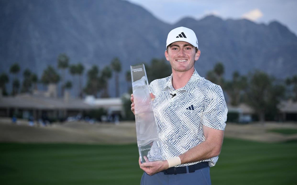 Nick Dunlap with the trophy after winning The American Express at Pete Dye Stadium Course in La Quinta, California