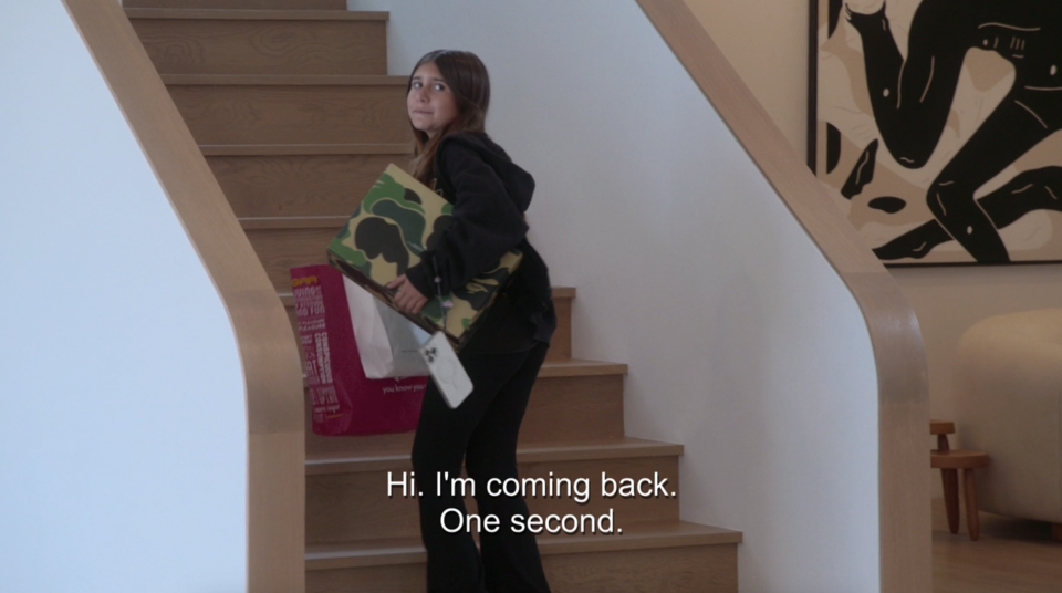 Penelope on the stairs with caption, "Hi, I'm coming back, one second"