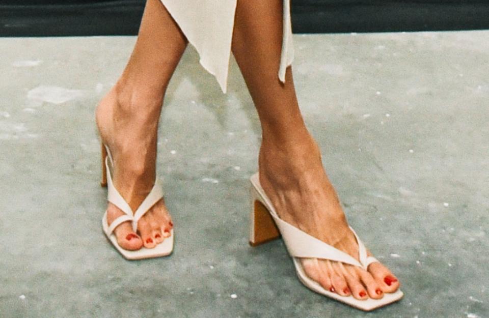A close-up shot of the strappy thong sandals featuring a big-toe loop design that Alessandra Ambrosio wore on Dec. 16, 2021. - Credit: Images courtesy of BFA/Linnea Stephan