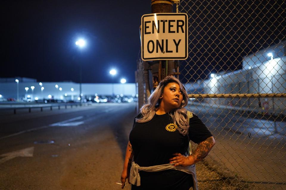 General Motors employee Dominique Birdsong smokes a cigarette in anticipation at an entrance to Flint Assembly before a national strike against General Motors after stalled contract negotiations with General Motors.