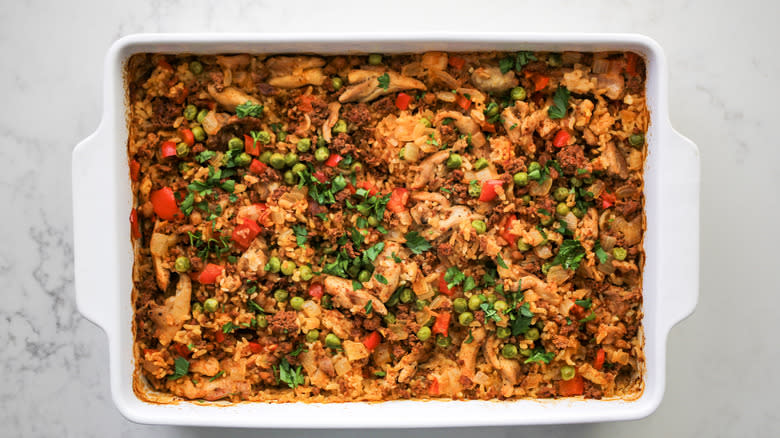 baked paella casserole topped with parsley
