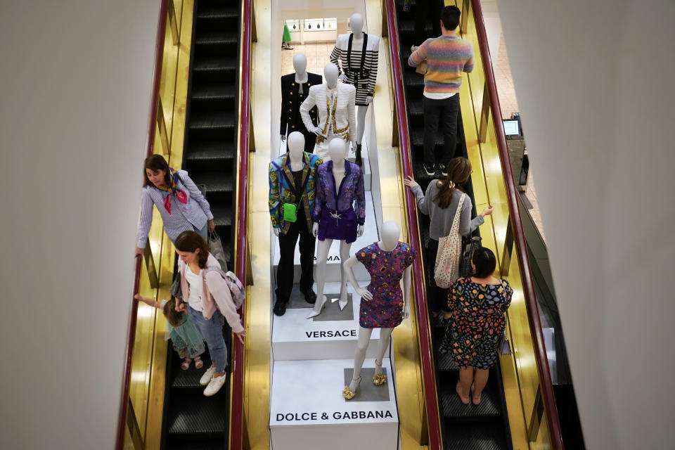 Shoppers move past displays of designer clothes at the Neiman Marcus department store in NorthPark shopping center in Dallas, Thursday, March 30, 2023. Wealthier shoppers are still spending freely even in the face of higher inflation and a volatile economic environment. Luxury retailer Neiman Marcus is doubling down on catering to its high end shoppers. (AP Photo/LM Otero)