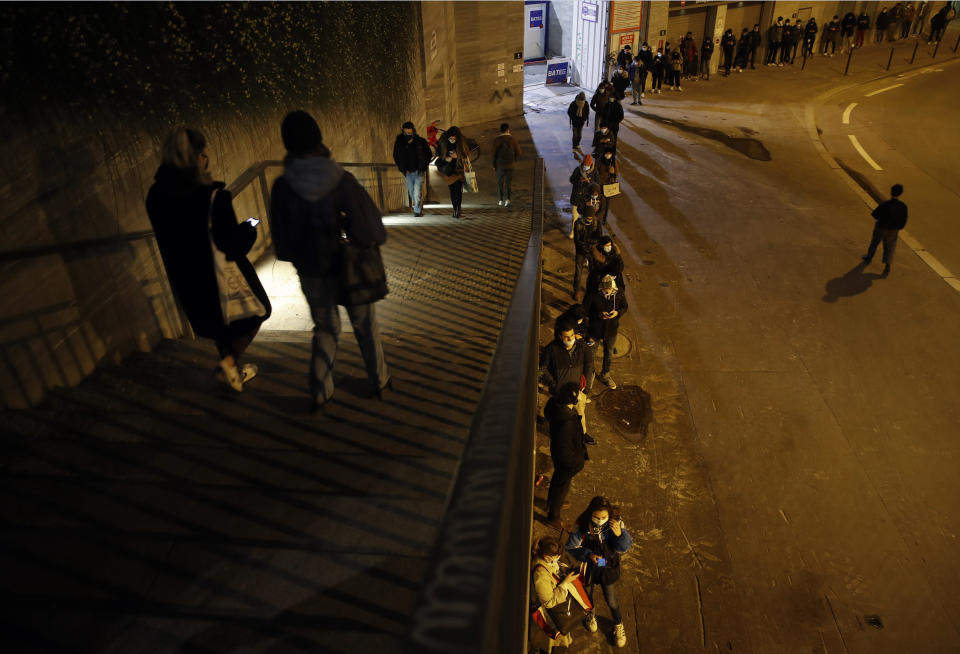 Students line up for free food aid organized by Linkee, a Paris-based company collecting food waste, in Paris, Monday, Feb. 1, 2021. A quarter of French young professionals can't find work, and many university students are standing in food lines or calling hotlines for psychological help. They are France's future, and their plight is central to the country's battle to emerge from the pandemic. (AP Photo/Christophe Ena)