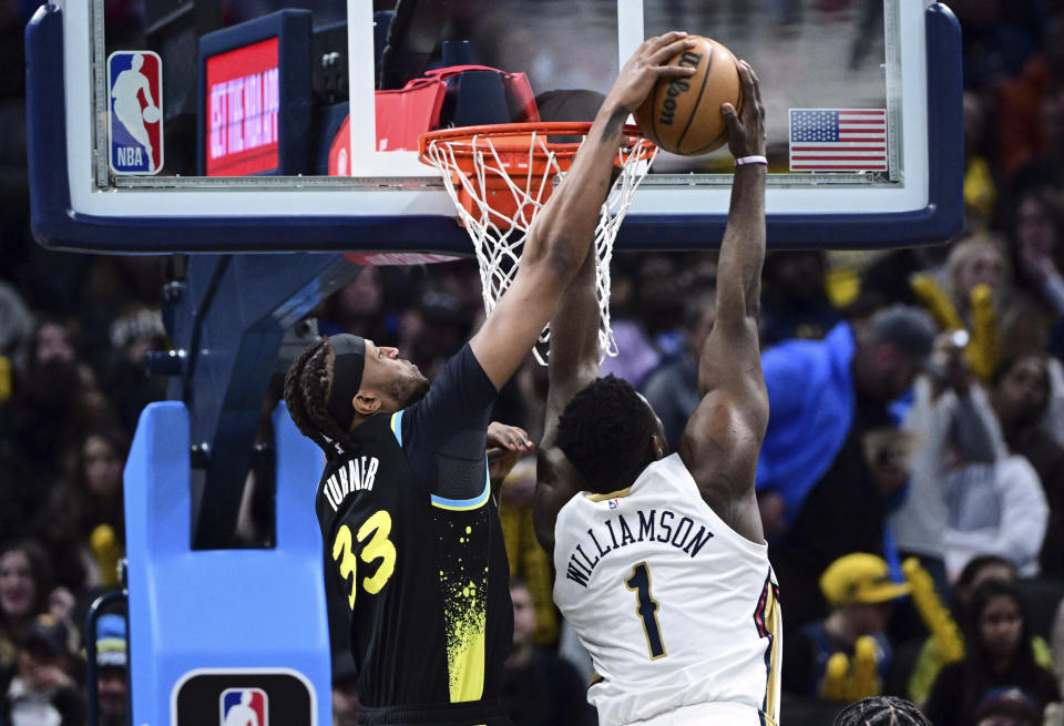Indiana Pacers center Myles Turner (33) blocks a shot by New Orleans Pelicans forward Zion Williamson (1) during the first half of an NBA basketball game Wednesday, Feb. 28, 2024, in Indianapolis. (AP Photo/Marc Lebryk)