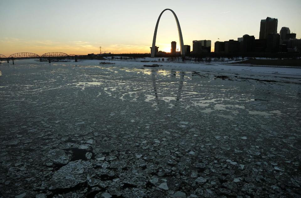 FILE - This Jan. 7, 2014 file photo shows ice in the Mississippi River flowing past the Gateway Arch in St. Louis. For a chilly and snowbound East, here’s a dose of cold reality: The nation’s temperature in January was pretty normal because a warm West offset a cool East. The National Oceanic Atmospheric Administration said January in the Lower 48 states was the 53rd coldest of 120 years. The nation averaged only one tenth of a degree below normal for January. (AP Photo/Jeff Roberson, File)