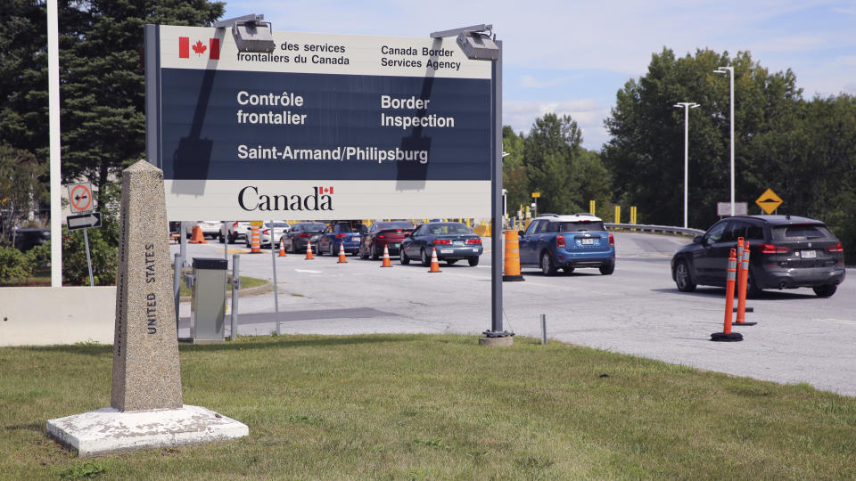 Cars pass a monument marking the border between the United States and Canada on Wednesday, Sept. 1, 2021, at Highgate Springs, Vt. U.S. Sen. Patrick Leahy (D-VT) and Robin Carnahan, the administrator of the U.S. General Services Administration, visited the port of entry with Canada to promote a $3 billion plan to build or modernize more than 30 land ports of entry across the US. (AP Photo/Wilson Ring)