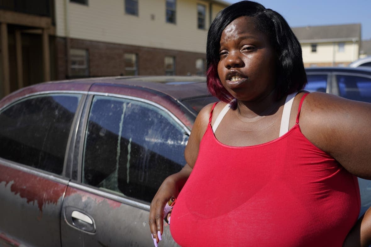 April Jackson stands outside her Jackson, Miss., apartment Oct. 5, 2022, and tells about the bureaucratic headaches she encountered as a single mother to collect a modest amount of Temporary Assistance for Needy Families (TANF) funds to help support her children who range in age from a few months to 13 years old. (AP Photo/Rogelio V. Solis)