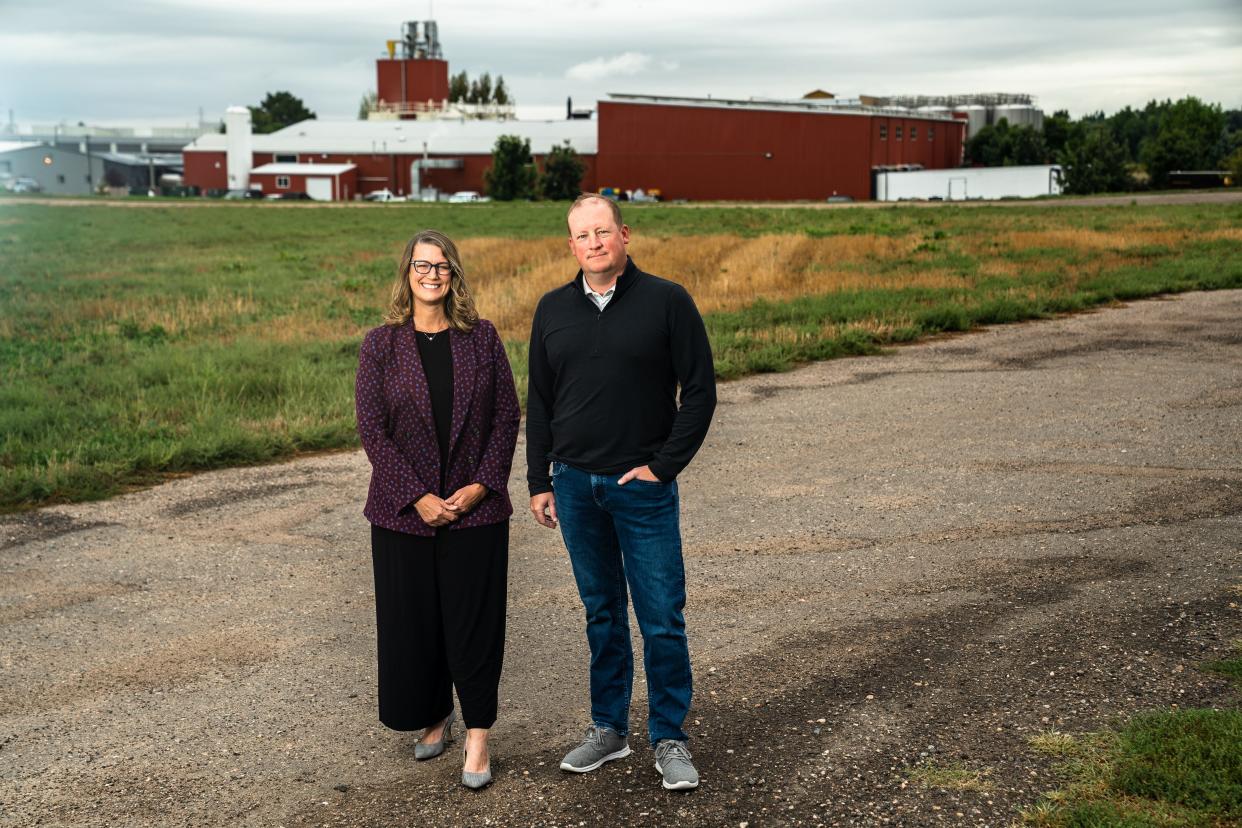 Kristin Candella, CEO of Habitat for Humanity, and Patrick McMeekin, president of land for Hartford Homes, are photographed at the site of a joint project behind Odell Brewing Company in September 2023, in Fort Collins. The project includes plans for 140 units to serve the housing needs of the "missing middle" on land donated by the Odell family.