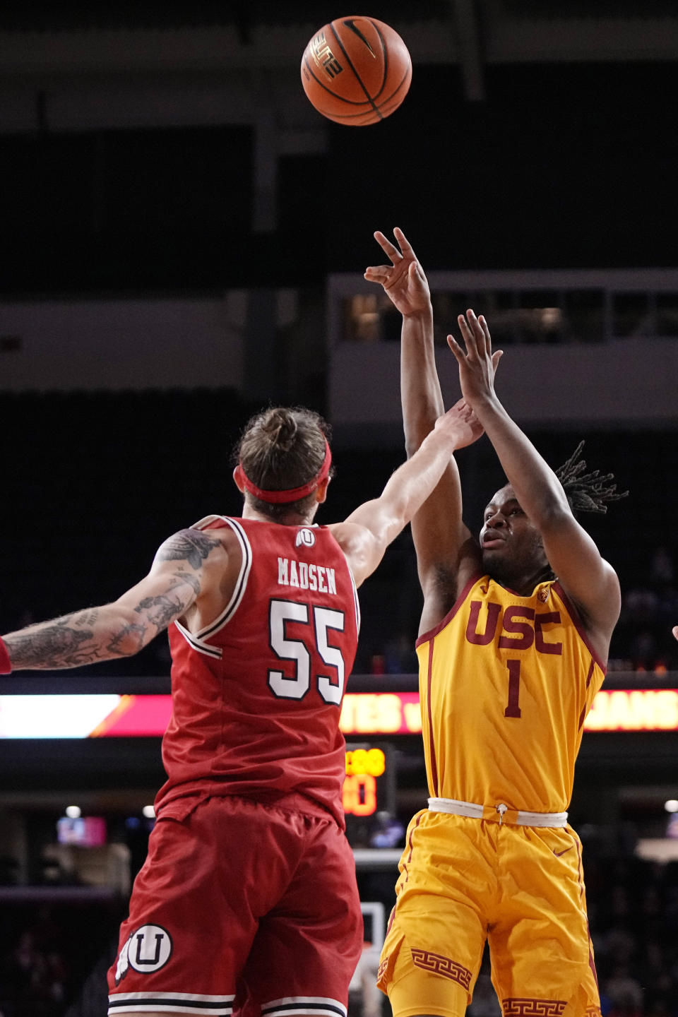 Southern California guard Isaiah Collier, right, shoots as Utah guard Gabe Madsen defends during the first half of an NCAA college basketball game Thursday, Feb. 15, 2024, in Los Angeles. (AP Photo/Mark J. Terrill)