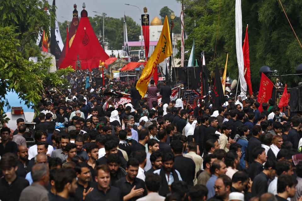 Shiite Muslims participate in a Muharram procession, in Islamabad, Pakistan, Monday, Aug. 8, 2022. Muharram, the first month of the Islamic calendar, is a month of mourning for Shiites in remembrance of the death of Hussein, the grandson of the Prophet Muhammad, at the Battle of Karbala in present-day Iraq in the 7th century. (AP Photo/Anjum Naveed)