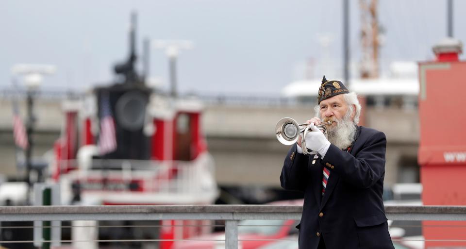 Taps is played by a member of American Legion 11 Post Green Bay during the inaugural Pearl Harbor remembrance ceremony outside the Door County Maritime Museum on Dec. 7, 2022, in Sturgeon Bay, Wis.