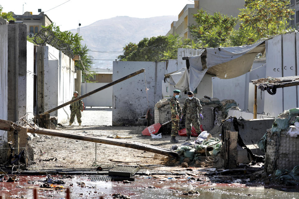 Afghan security forces work at the site of a suicide attack near the U.S. Embassy in Kabul, Afghanistan, Tuesday, Sept. 17, 2019. Hours earlier Afghan officials said a suicide bomber rammed his motorcycle packed with explosives into the entrance to a campaign rally of President Ashraf Ghani in northern Parwan province, killing over 20 people and wounding over 30. Ghani was present at the venue but was unharmed. The Taliban have claimed both attacks. (AP Photo/Ebrahim Noroozi)